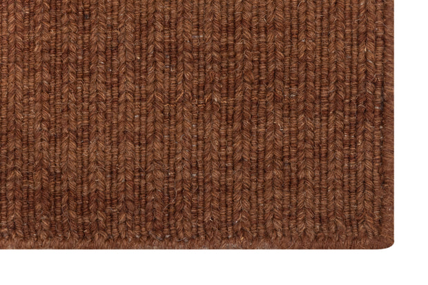 Close-up of Brown Texture Hand-Woven Soumak woolen rug for bed rooms, offices, and dining spaces. 